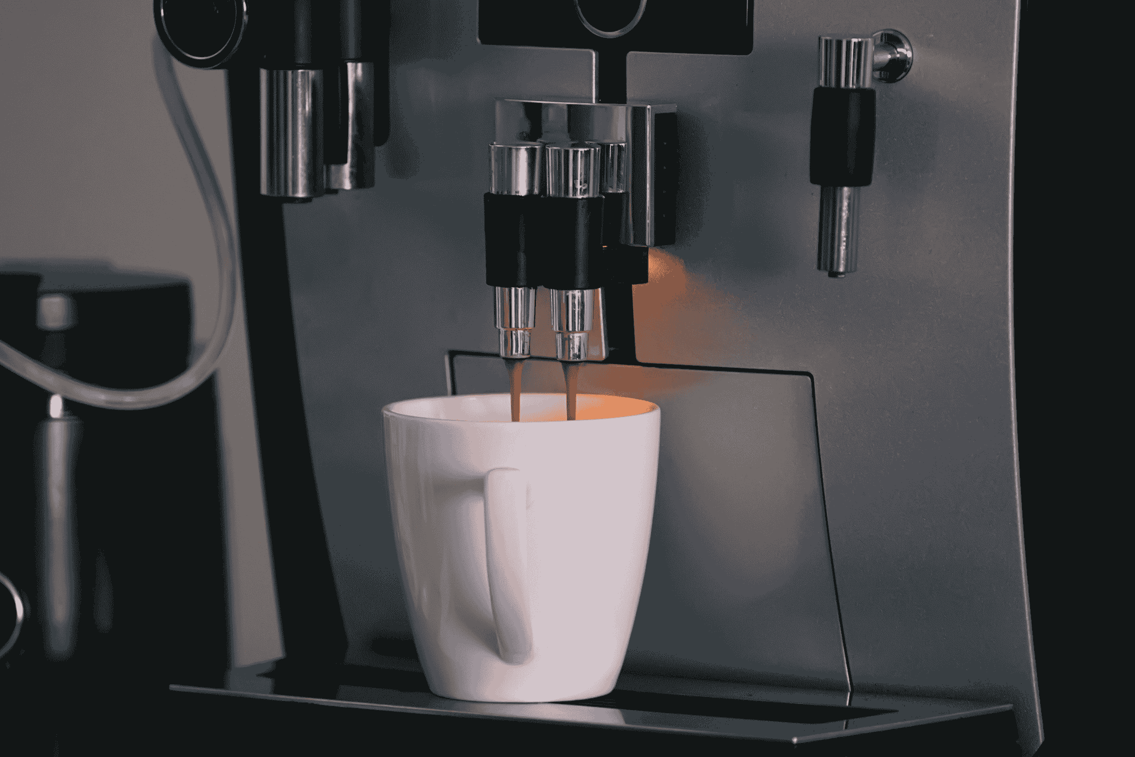 Reparatur Ersatzteile (2) Kaffee läuft aus einem Vollautomaten in eine weiße Kaffeetasse